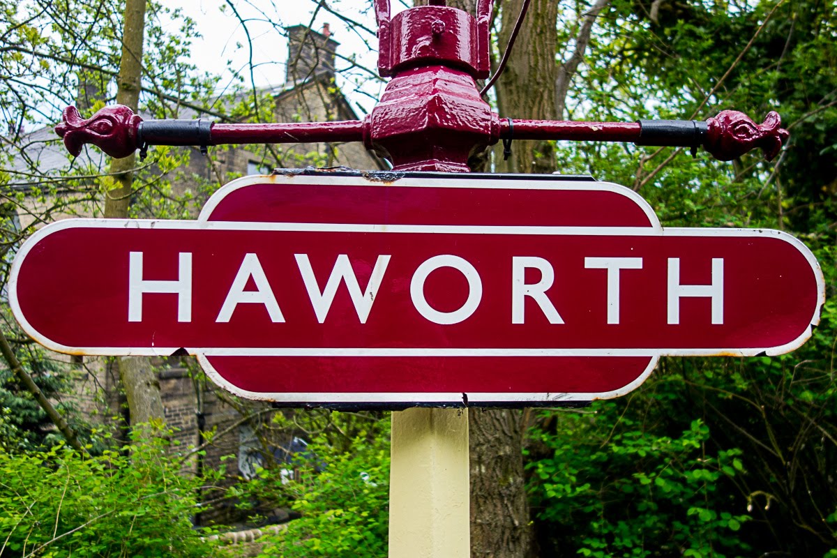 maroon haworth sign at the haworth train station