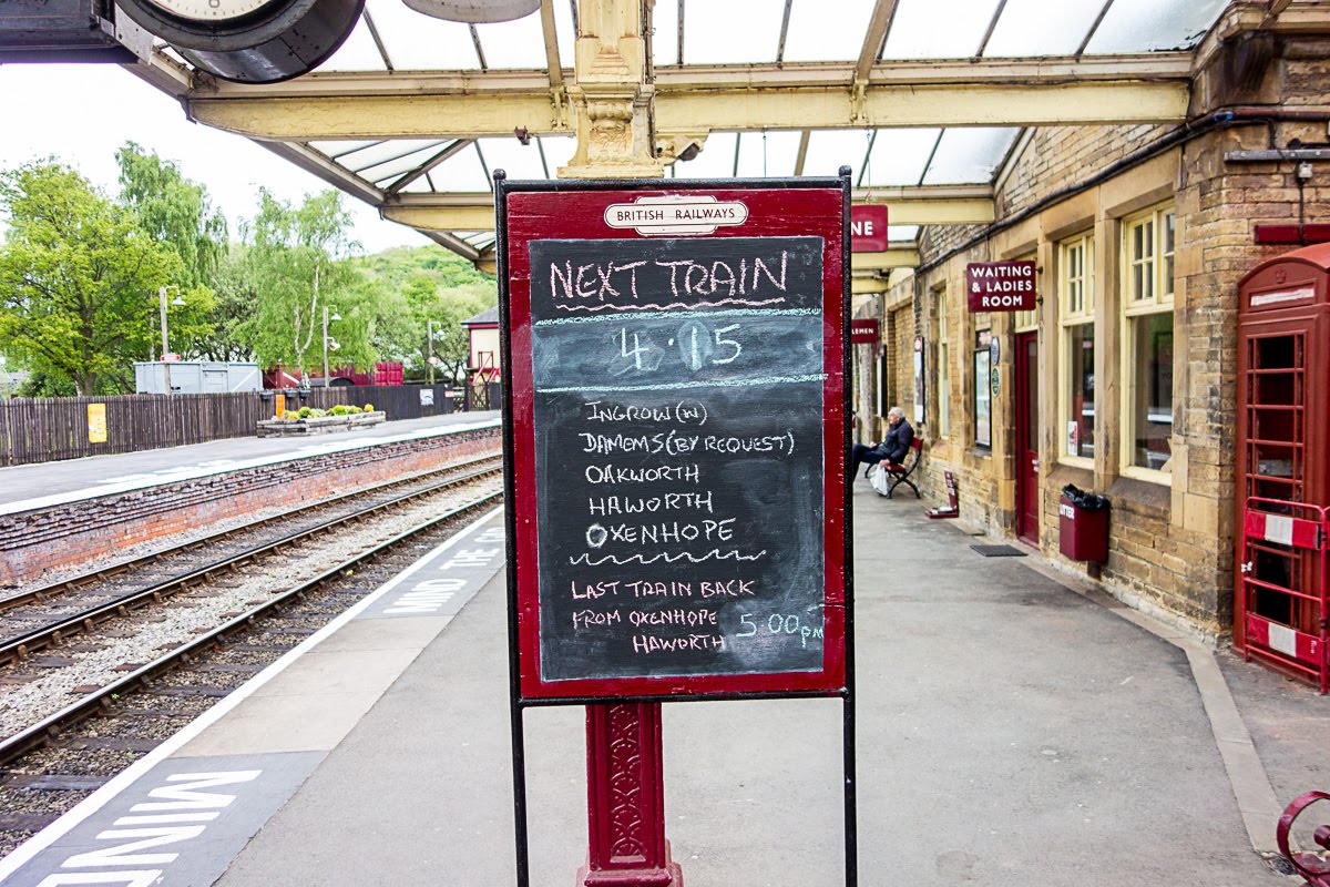 maroon signs at the keighley train station