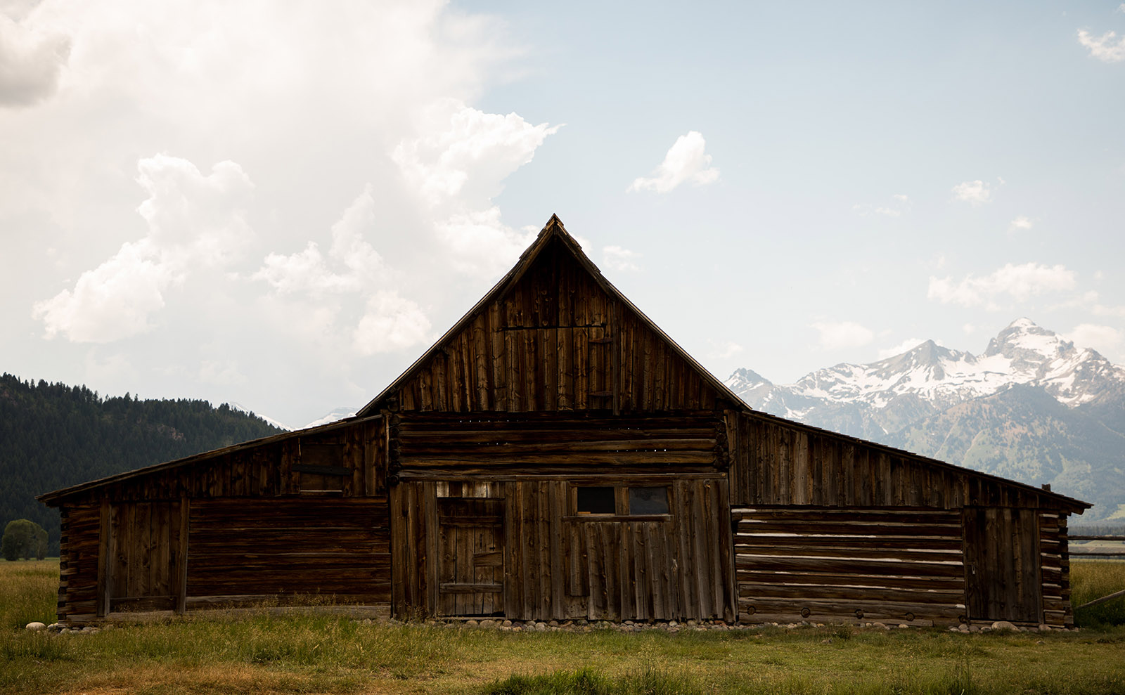 abandoned barn in front of mountains